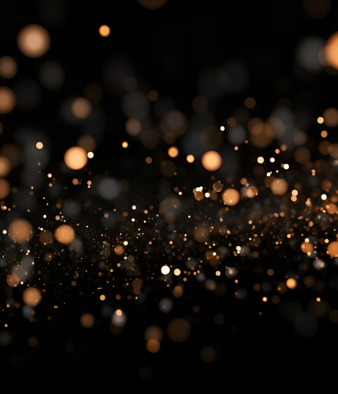 Schwarzer Hintergrund mit vielen orangefarbenen Lichtpunkten in unscharfer Darstellung.